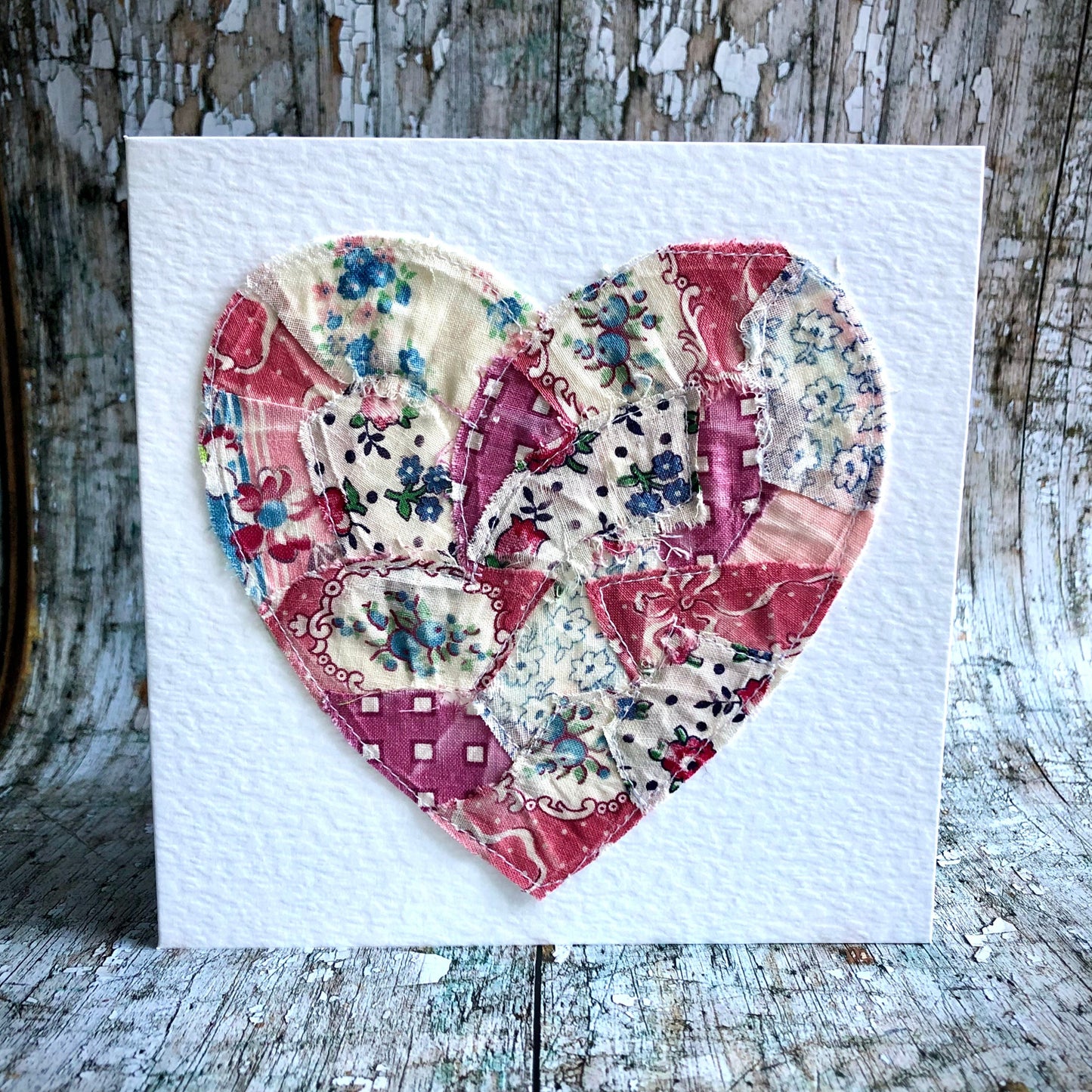 Vintage Feed Sack Card no.5
A beautifully made one of a kind greeting card suitable for any occasion, or just to frame. The heart has been made by carefully patching together sections of genuine vintage feed sack fabrics from the 30's - 50's, on good quality white 225 gsm hammered card, with a simple white envelope in a cello bag. The back of the card is printed with the history of American feed sack fabrics, and the inside left blank for your own special message.
Size: 6" x 6" / 15cm x 15cm.