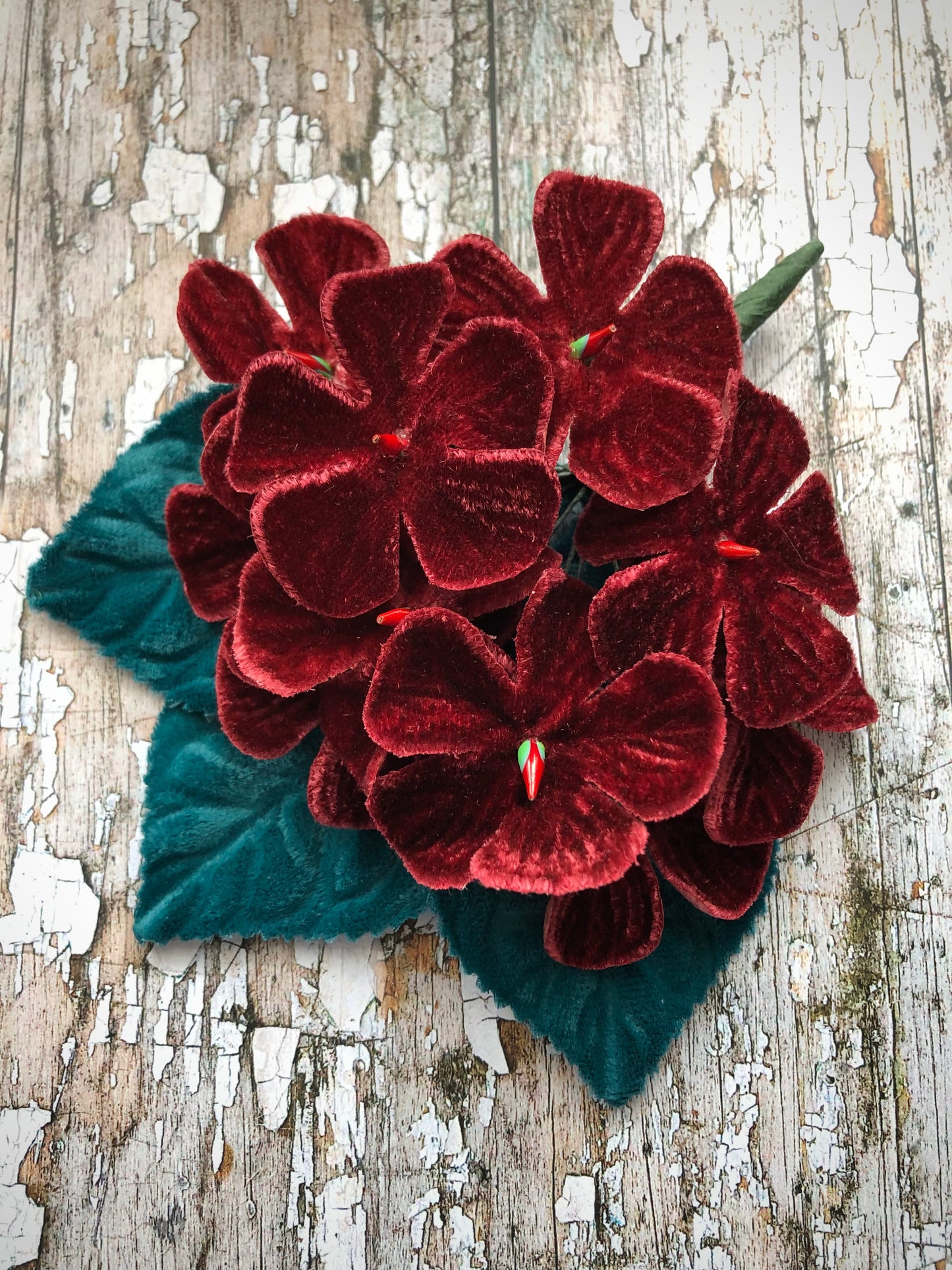 Vintage Velvet Flowers
This brooch has been made with unused old stock vintage millinery flowers.
Perfect as a gift for a vintage fan, dressing up, display or photo prop.
Made with 10 wine coloured velvet flocked vintage millinery flowers, 3 blue velvet leaves which were custom made from vintage velvet and a silver coloured pin back brooch with a revolver safety catch.
Measurements Approximately:
Width: 12 cm / 4 + 1/2"
Length: 14 .5 cm / 5 + 3/4"