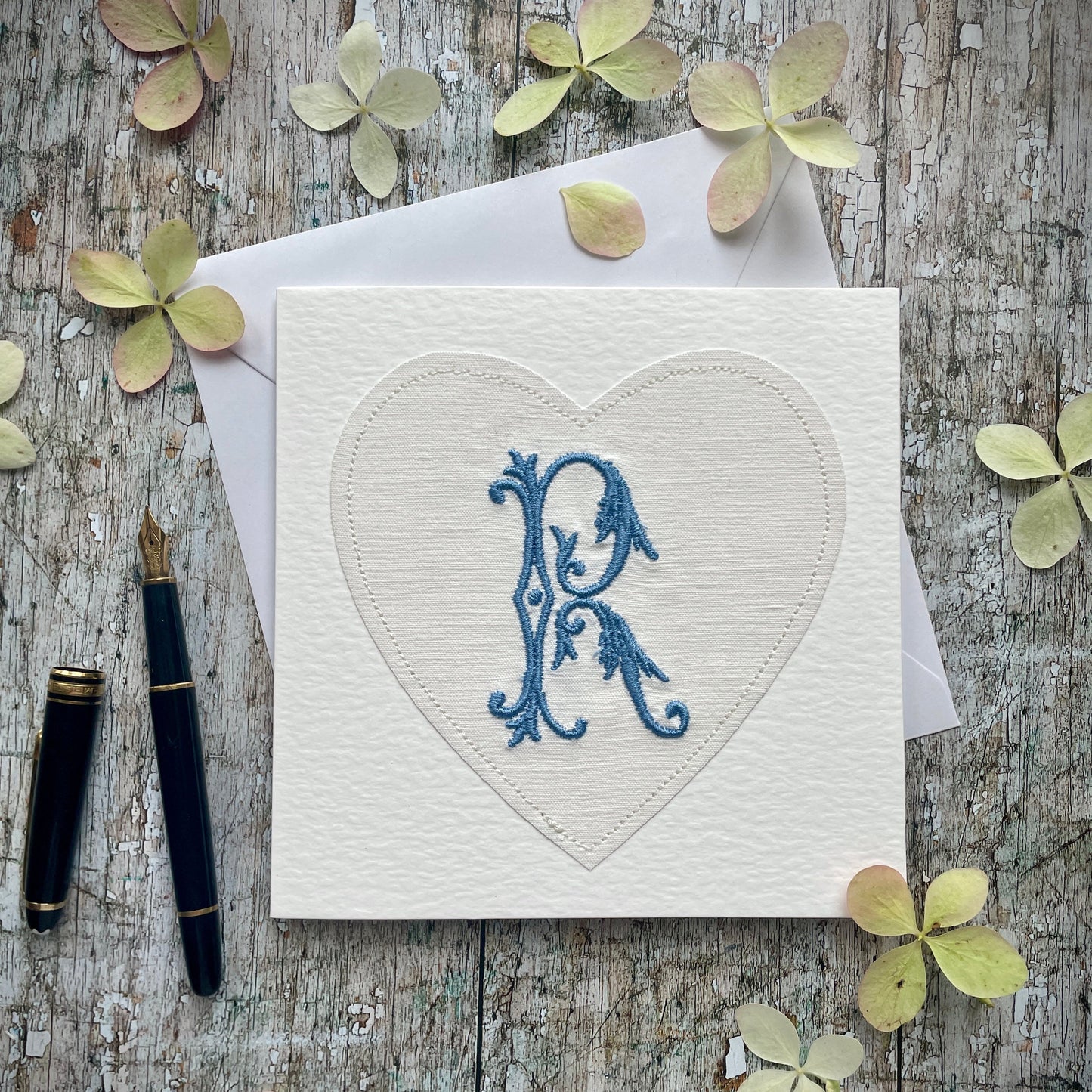 Embroidered Initial Card Blue R
Beautifully made one of a kind romantic card suitable for any occasion, or just to frame. The initial R has been embroidered with blue colour thread onto a piece of heart shaped vintage linen, then sewn onto a good quality acid free white 225 gsm hammered card, the inside left blank for your own special message. It comes with a simple white envelope in a cello bag.
Size: 6" x 6" / 15cm x 15cm