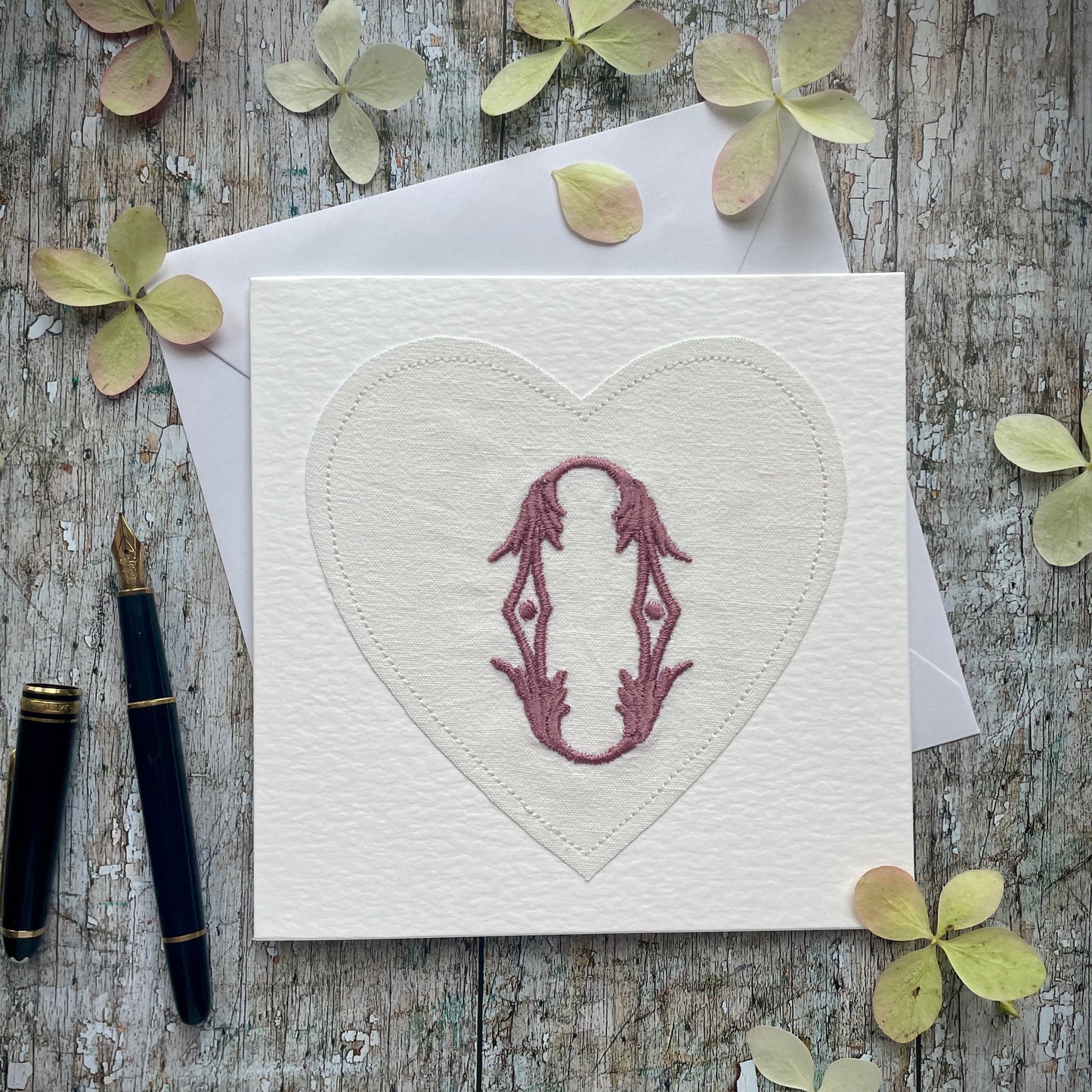 Embroidered Initial Card Mulberry O
Beautifully made one of a kind romantic card suitable for any occasion, or just to frame. The initial O has been embroidered with mulberry colour thread onto a piece of heart shaped vintage linen, then sewn onto a good quality acid free white 225 gsm hammered card, the inside left blank for your own special message. It comes with a simple white envelope in a cello bag.
Size: 6" x 6" / 15cm x 15cm