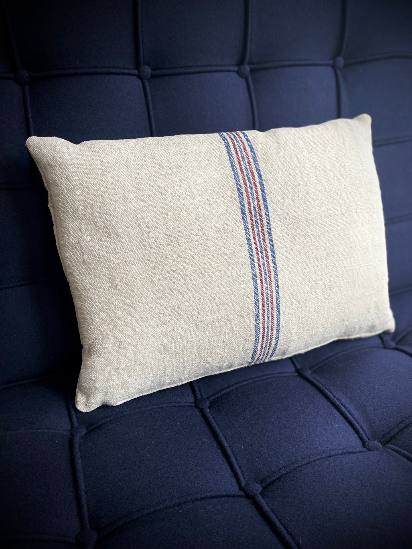 Vintage Hemp Grain Sack Cushion
Made by: Karen - vintage on the coast
This cream coloured hemp cushion has a wonderful slub texture and has been beautifully made from a vintage hemp grain sack with woven vertical lines on both sides in blue and maroon. The cushion is filled with a plump feather pad and has a zip closure.
Size approximately:: 48 cm X 36 cm / 19" X 14".