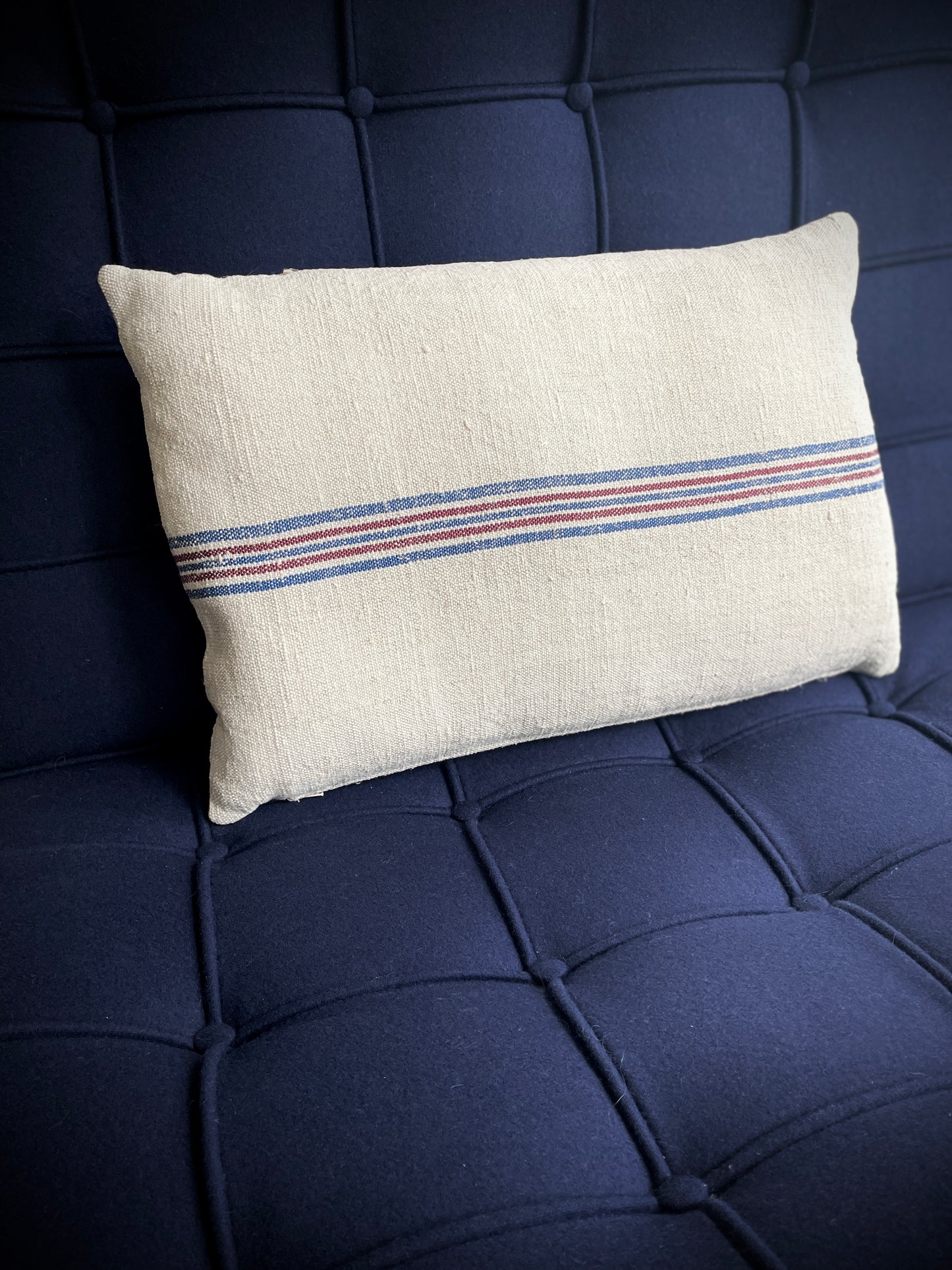 Vintage Hemp Grain Sack Cushion
Made by: Karen - vintage on the coast
This cream coloured hemp cushion has a wonderful slub texture and has been beautifully made from a vintage hemp grain sack with woven horizontal lines on both sides in blue and maroon. The cushion is filled with a plump feather pad and has a zip closure.
Size approximately:: 50 cm X 134 cm / 19+1/2" X 13+1/2".