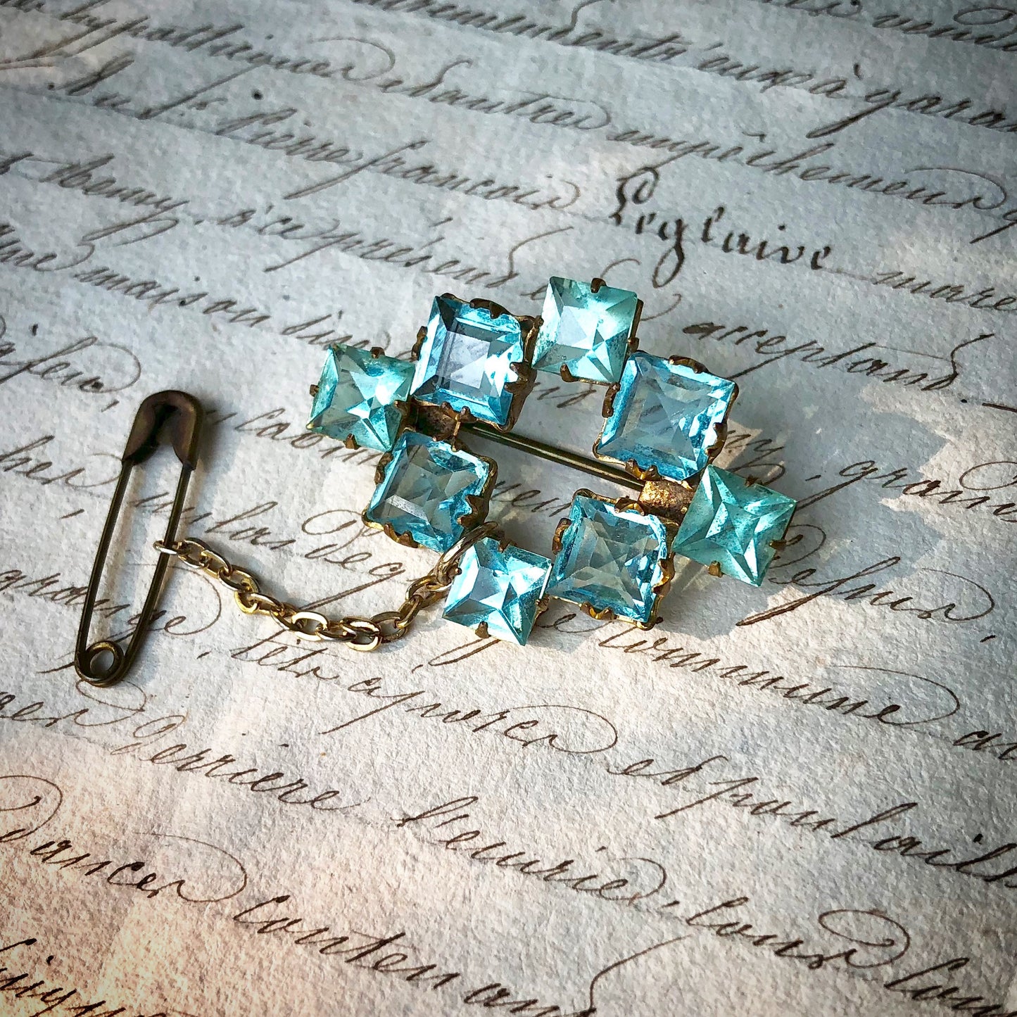 1940's Rhinestone Brooch
Genuine vintage jewellery not reproduction. A very pretty vintage 1940's brooch in two shades of sparkling aquamarine coloured rhinestones, secure in their settings, on a gold coloured metal back, with the added benefit of an attached chain and safety pin. A really beautiful brooch in very good condition, perfect for dressing up or adding the finishing touch to an outfit.