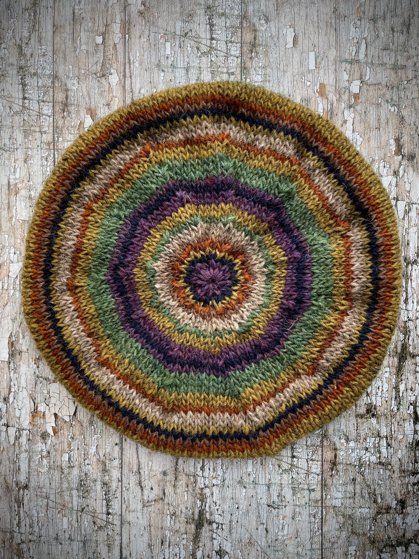 Classic 40's Style Beret no.18
Beautifully hand knitted beret in Icelandic wool, perfect for keeping your head warm on cold days and adding a touch of 40's style to any outfit. Knitted green heather, dark oat, kelp, violet heather, navy, burnt orange and milk chocolate stripes, with a green heather ribbed band that gives the hat a snug fit.
SIZE: adult.
CARE: hand wash or machine wash on wool cycle at 30 degrees, dry flat, do not tumble dry.