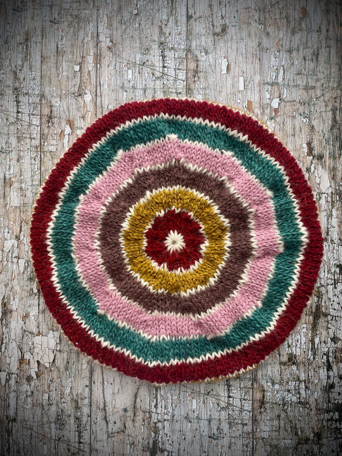 STRIPED PURE WOOL BERET
Beautifully hand knitted striped beret in a mixture of Icelandic, British and Peruvian pure wools, perfect for keeping your head warm on cold days. Knitted in viridian, white, rose, umber,, kelp and garnet with a ribbed band that gives the hat a snug fit.