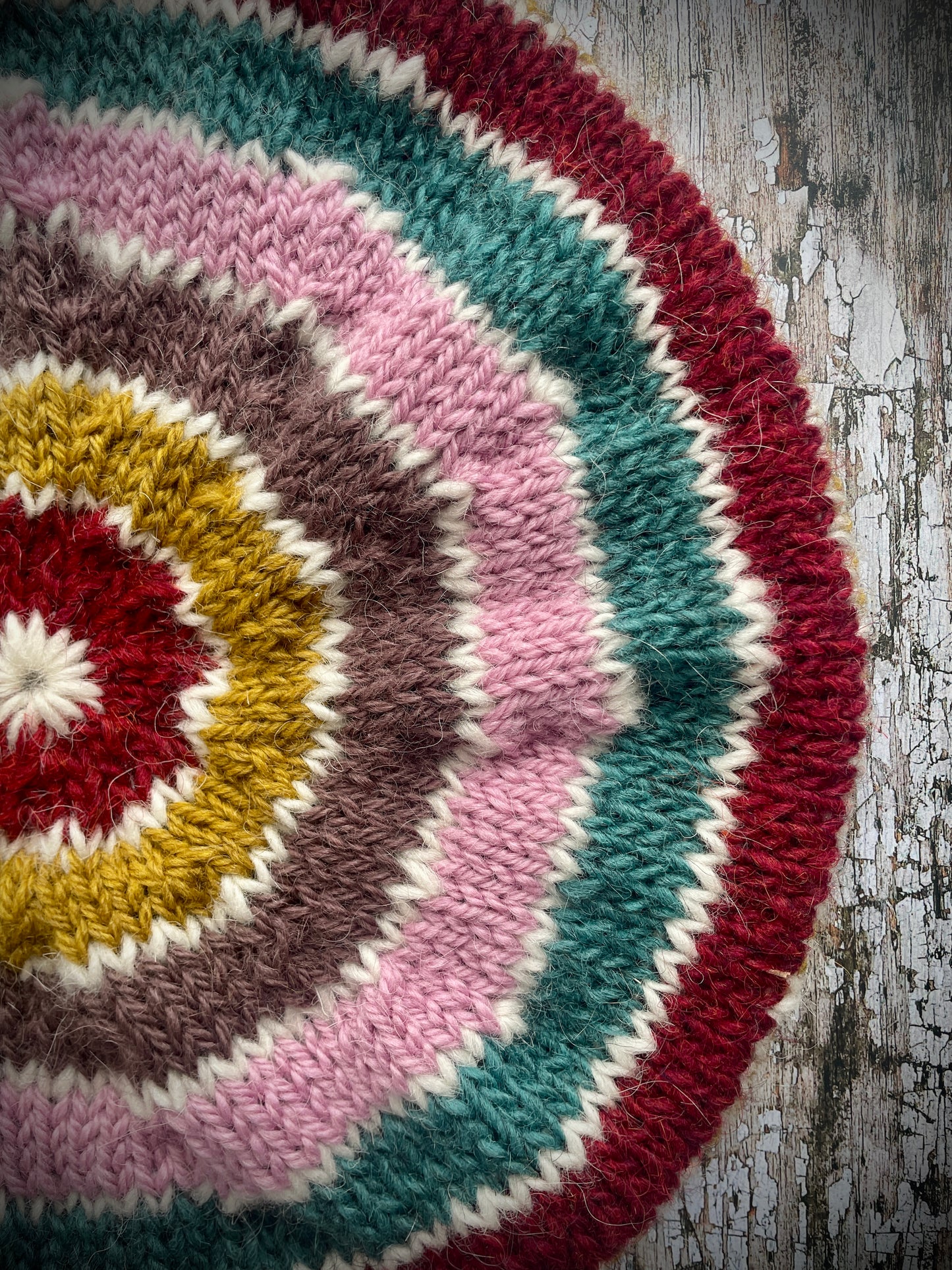 STRIPED PURE WOOL BERET
Beautifully hand knitted striped beret in a mixture of Icelandic, British and Peruvian pure wools, perfect for keeping your head warm on cold days. Knitted in viridian, white, rose, umber,, kelp and garnet with a ribbed band that gives the hat a snug fit.