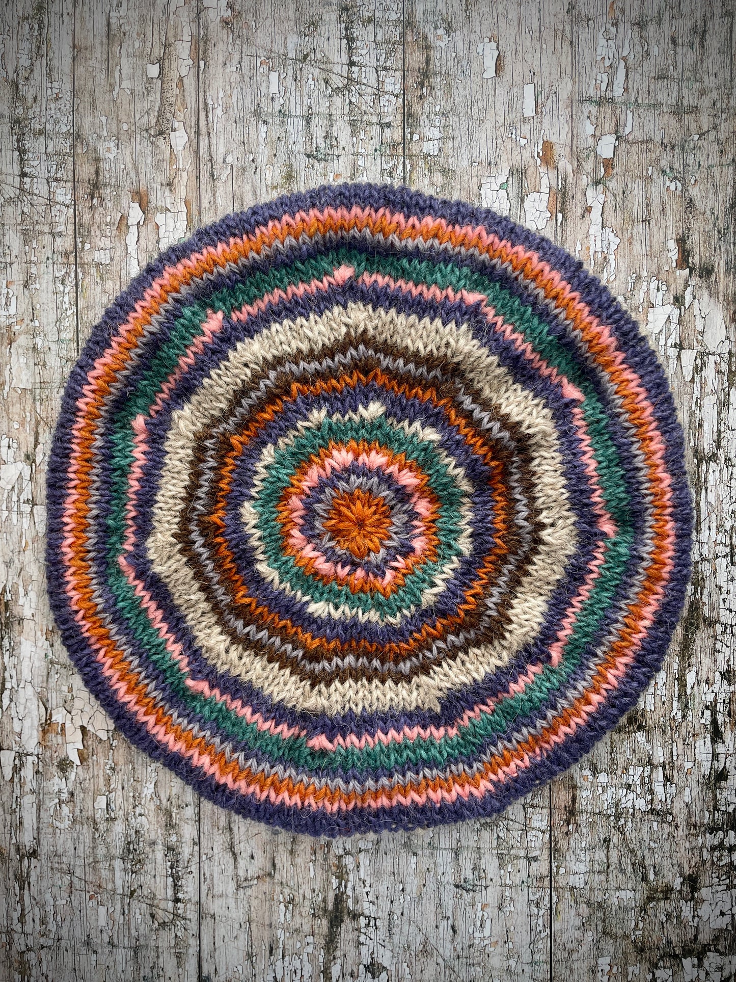 Beautifully hand knitted beret in Icelandic wool, perfect for keeping your head warm on cold days and adding a touch of 40's style to any outfit. Knitted in oat, viridian, violet, dark chocolate, mauve, pink and orange stripes, with an oat ribbed band that gives the hat a snug fit.
SIZE: adult.
CARE: hand wash or machine wash on wool cycle at 30 degrees, dry flat, do not tumble dry.