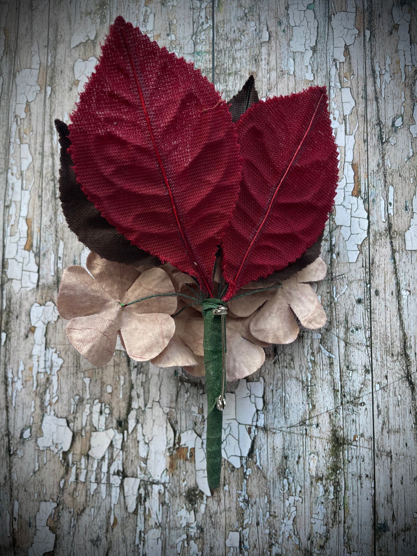 Dusky Pink Flowers + Red + Brown Leaves Brooch

This brooch contains unused old stock vintage millinery flowers, therefore like all vintage and antique items they may show slight signs of age.
Perfect as a gift for a vintage fan, dressing up, costumes, display and photo props.

I have made this brooch with 10 dusky pink velvet flocked vintage millinery flowers, 2 red and 3 dark chocolate brown leaves which were custom made from vintage velvet and a silver tone pin back brooch with a revolver safety catch. 