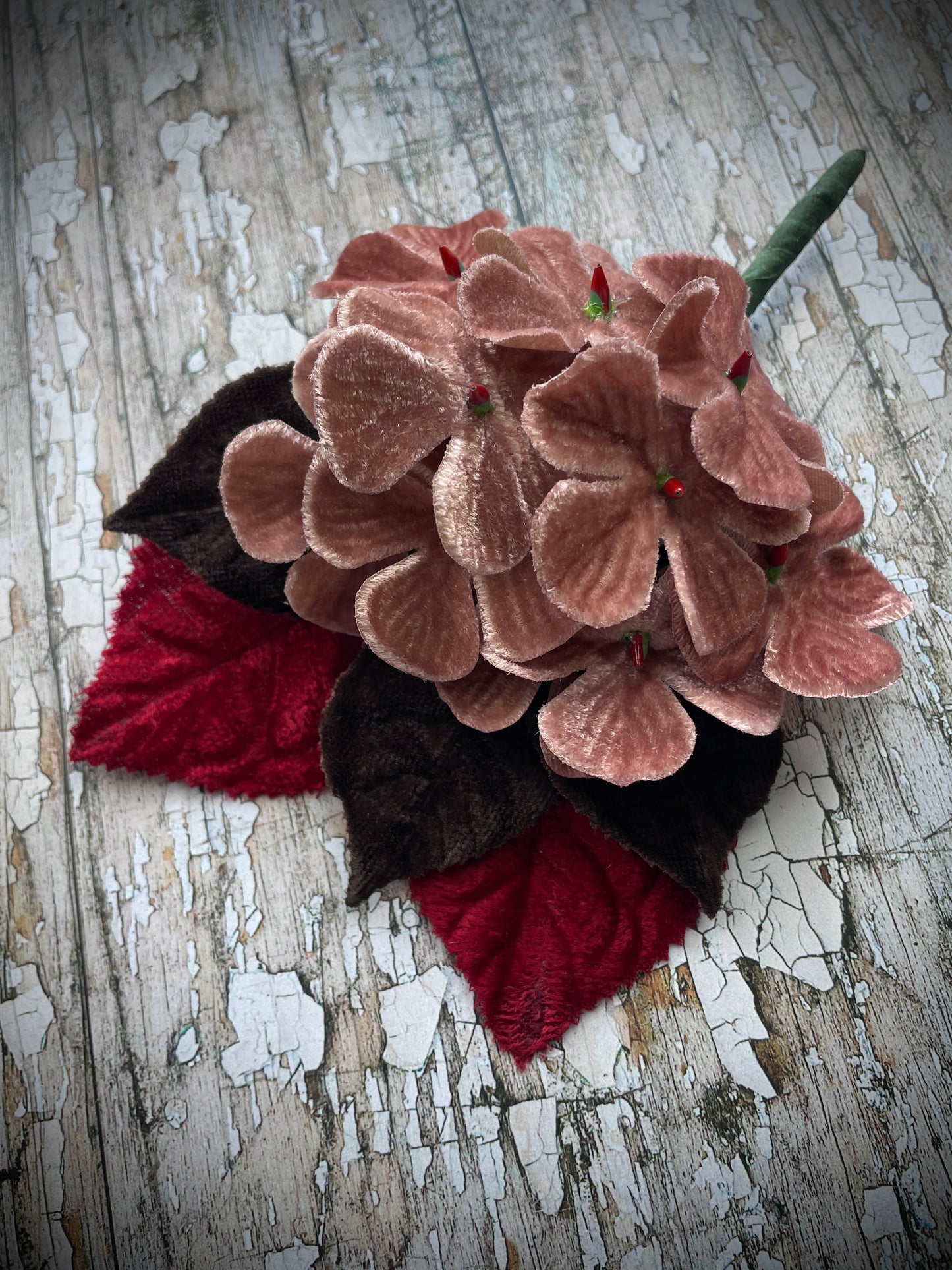 Dusky Pink Flowers + Red + Brown Leaves Brooch

This brooch contains unused old stock vintage millinery flowers, therefore like all vintage and antique items they may show slight signs of age.
Perfect as a gift for a vintage fan, dressing up, costumes, display and photo props.

I have made this brooch with 10 dusky pink velvet flocked vintage millinery flowers, 2 red and 3 dark chocolate brown leaves which were custom made from vintage velvet and a silver tone pin back brooch with a revolver safety catch. 