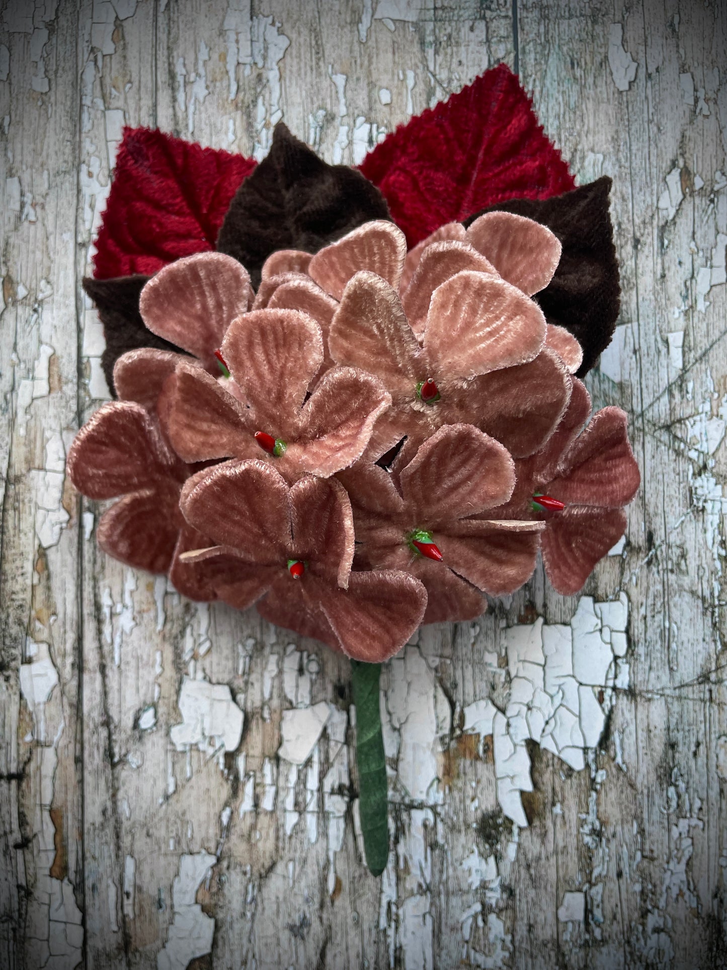 Dusky Pink Flowers + Red + Brown Leaves Brooch

This brooch contains unused old stock vintage millinery flowers, therefore like all vintage and antique items they may show slight signs of age.
Perfect as a gift for a vintage fan, dressing up, costumes, display and photo props.

I have made this brooch with 10 dusky pink velvet flocked vintage millinery flowers, 2 red and 3 dark chocolate brown leaves which were custom made from vintage velvet and a silver tone pin back brooch with a revolver safety catch. 