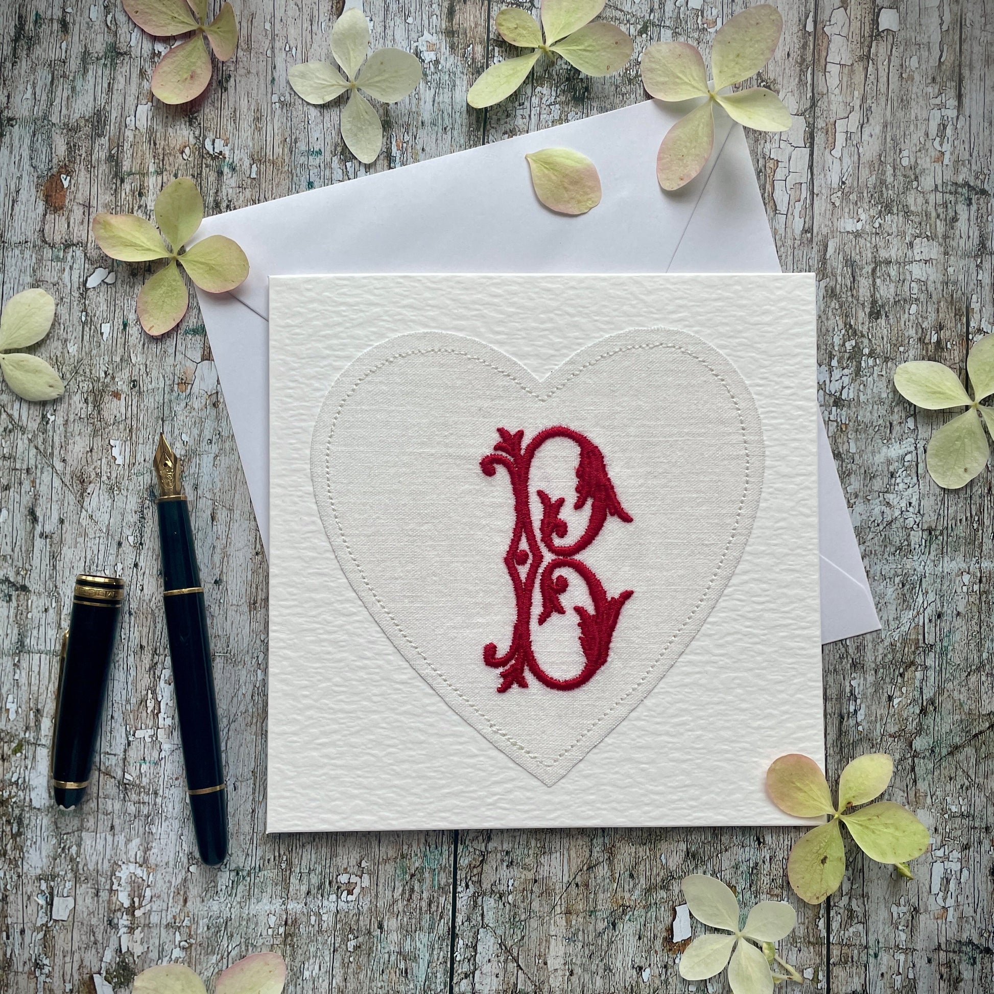 Embroidered Initial Card Red B

Beautifully made one of a kind romantic card suitable for any occasion, or just to frame. The initial B has been embroidered with red colour thread onto a piece of heart shaped vintage linen, then sewn onto a good quality white 225 gsm hammered card, the inside left blank for your own special message. It comes with a simple white envelope in a cello bag.

Size: 6" x 6" / 15cm x 15cm