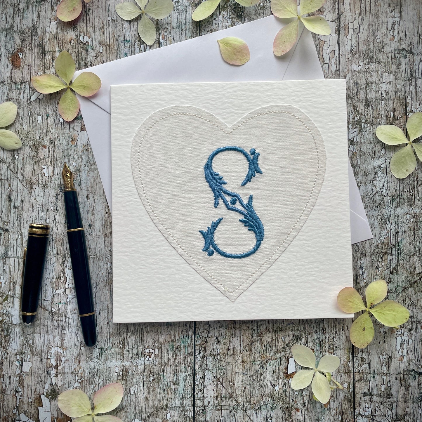 Embroidered Initial Card Blue S

Beautifully made one of a kind romantic card suitable for any occasion, or just to frame. The initial S has been embroidered with blue colour thread onto a piece of heart shaped vintage linen, then sewn onto a good quality acid free white 225 gsm hammered card, the inside left blank for your own special message. It comes with a simple white envelope in a cello bag.

Size: 6" x 6" / 15cm x 15cm