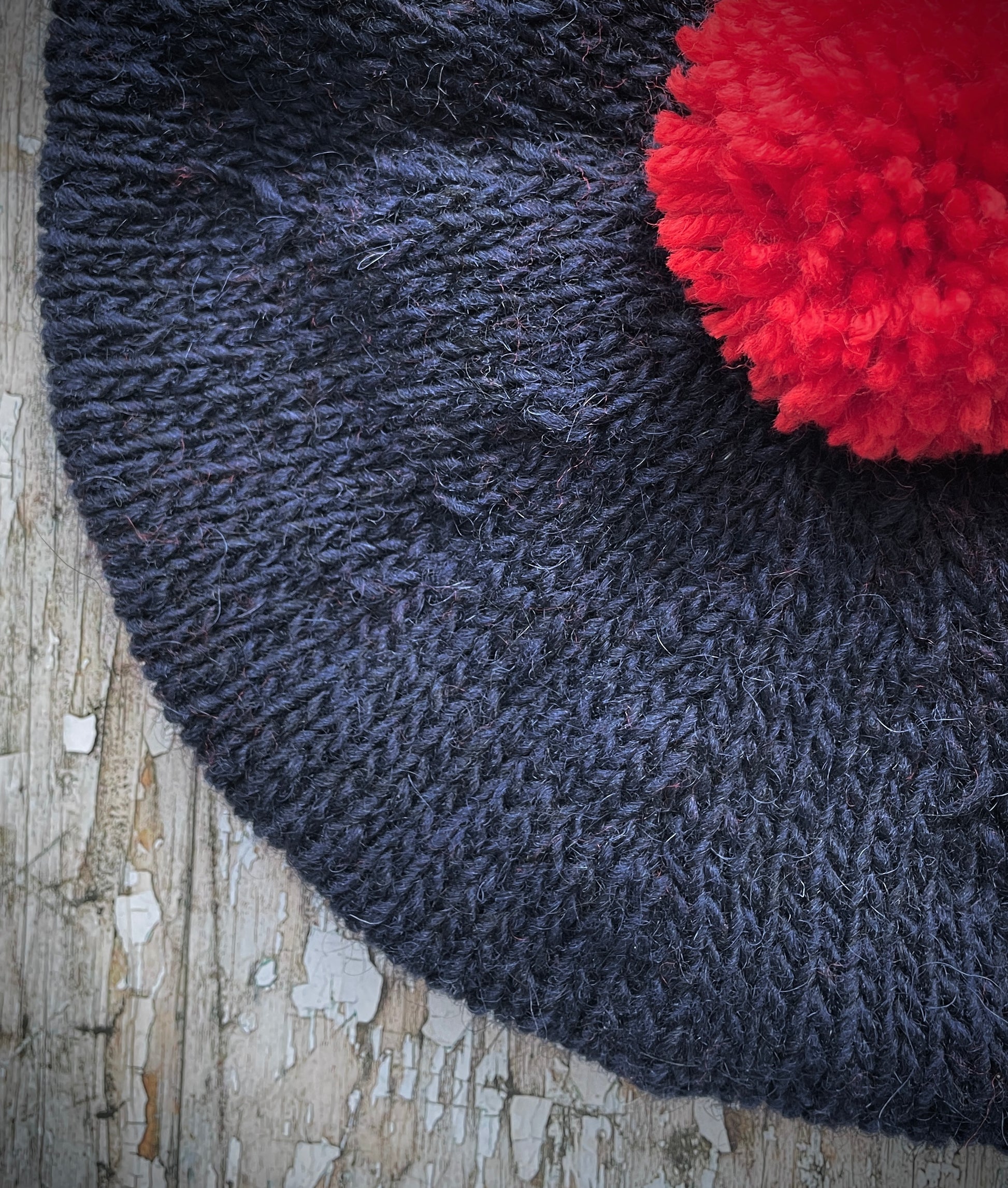 Hand Knitted Wool Beret Navy Blue + Red

Beautifully hand knitted beret in Icelandic Lettlopi pure wool, perfect for keeping your head warm on cold days. Knitted in a dark navy blue colour with a bright red pom and navy blue ribbed band that gives the hat a snug fit.

SIZE: adult.

CARE: hand wash or machine wash on wool cycle at 30 degrees, dry flat, do not tumble dry.