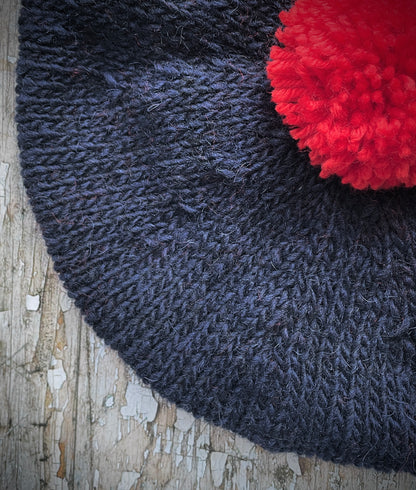Hand Knitted Wool Beret Navy Blue + Red

Beautifully hand knitted beret in Icelandic Lettlopi pure wool, perfect for keeping your head warm on cold days. Knitted in a dark navy blue colour with a bright red pom and navy blue ribbed band that gives the hat a snug fit.

SIZE: adult.

CARE: hand wash or machine wash on wool cycle at 30 degrees, dry flat, do not tumble dry.