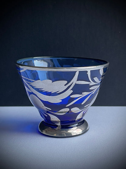 Vintage Silvered Tea Light Holder

This beautiful, small, delicate and rare vintage silvered glass is cobalt blue in colour and overlayed in silver with a pretty hand painted design of leaves and berries. It was made in Italy and originally designed to be used as a cordial or liqueur glass, but is perfect as an original candle and tea light holder.

There are 6 glasses available, all in very good vintage condition with no cracks.