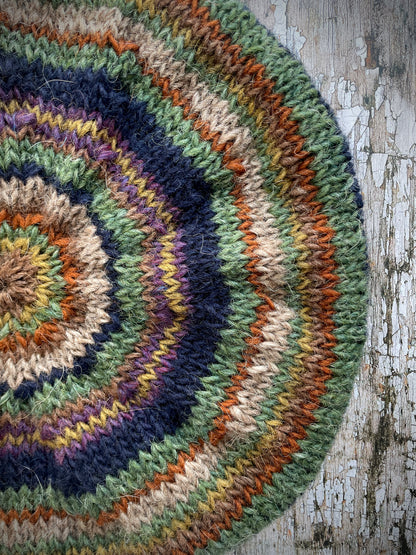 Classic 40's Style Beret no.7

Beautifully hand knitted beret in Icelandic wool, perfect for keeping your head warm on cold days and adding a touch of 40's style to any outfit. Knitted in navy, dark oat, lyme green, violet heather, kelp, burnt orange and milk chocolate stripes, with a navy ribbed band that gives the hat a snug fit.

SIZE: adult.&nbsp;

CARE: hand wash or machine wash on wool cycle at 30 degrees, dry flat, do not tumble dry.