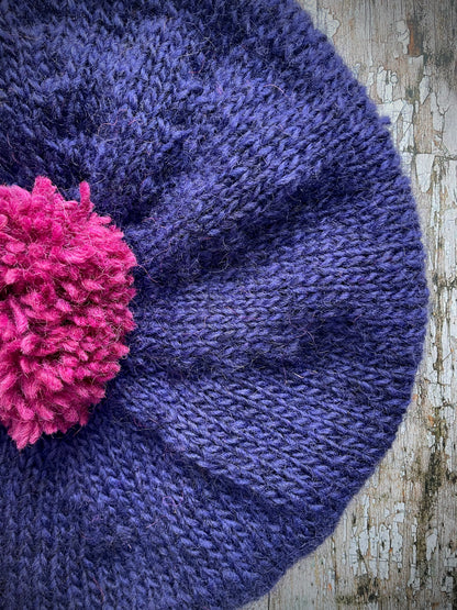 Hand Knitted Wool Dark Royal Blue + Fuchsia Beret

Beautifully hand knitted beret in Icelandic pure wool, perfect for keeping your head warm on cold days. Knitted in a beautiful dark royal blue, a deep, vibrant and rich shade of blue, lighter than navy blue with subtle purple undertones and fuchsia, with a big fuchsia pom and fuchsia ribbed band that gives the hat a snug fit.

SIZE: adult.

CARE: hand wash or machine wash on wool cycle at 30 degrees, dry flat, do not tumble dry.