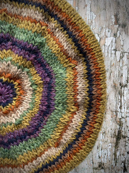 Classic 40's Style Beret no.18

Beautifully hand knitted beret in Icelandic wool, perfect for keeping your head warm on cold days and adding a touch of 40's style to any outfit. Knitted green heather, dark oat, kelp, violet heather, navy, burnt orange and milk chocolate stripes, with a green heather ribbed band that gives the hat a snug fit.

SIZE: adult.

CARE: hand wash or machine wash on wool cycle at 30 degrees, dry flat, do not tumble dry.