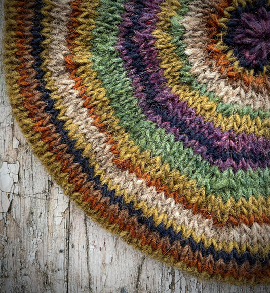 Classic 40's Style Beret no.18

Beautifully hand knitted beret in Icelandic wool, perfect for keeping your head warm on cold days and adding a touch of 40's style to any outfit. Knitted green heather, dark oat, kelp, violet heather, navy, burnt orange and milk chocolate stripes, with a green heather ribbed band that gives the hat a snug fit.

SIZE: adult.

CARE: hand wash or machine wash on wool cycle at 30 degrees, dry flat, do not tumble dry.
