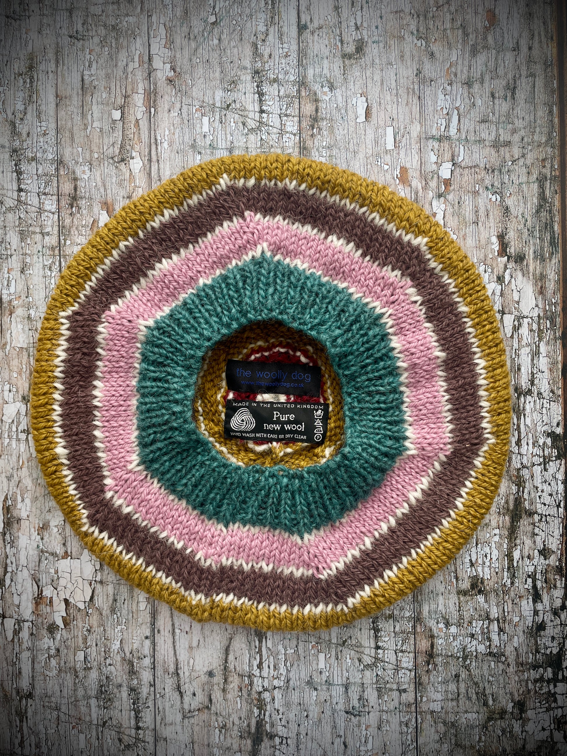 STRIPED PURE WOOL BERET

Beautifully hand knitted striped beret in a mixture of Icelandic, British and Peruvian pure wools, perfect for keeping your head warm on cold days. Knitted in viridian, white, rose, umber,, kelp and garnet with a ribbed band that gives the hat a snug fit.