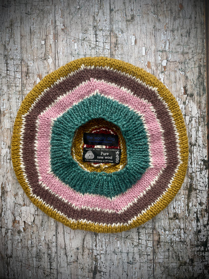 STRIPED PURE WOOL BERET

Beautifully hand knitted striped beret in a mixture of Icelandic, British and Peruvian pure wools, perfect for keeping your head warm on cold days. Knitted in viridian, white, rose, umber,, kelp and garnet with a ribbed band that gives the hat a snug fit.