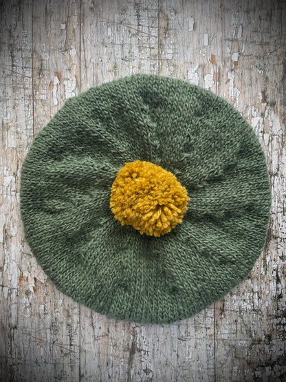 Beautifully hand knitted beret in sage green heather Icelandic wool and a rich yellow BFL wool, perfect for keeping your head warm on cold days, with a ribbed band of sage green that gives the hat a snug fit.

SIZE: Adult.

CARE: hand wash or machine wash on wool cycle at 30 degrees, dry flat, do not tumble dry.