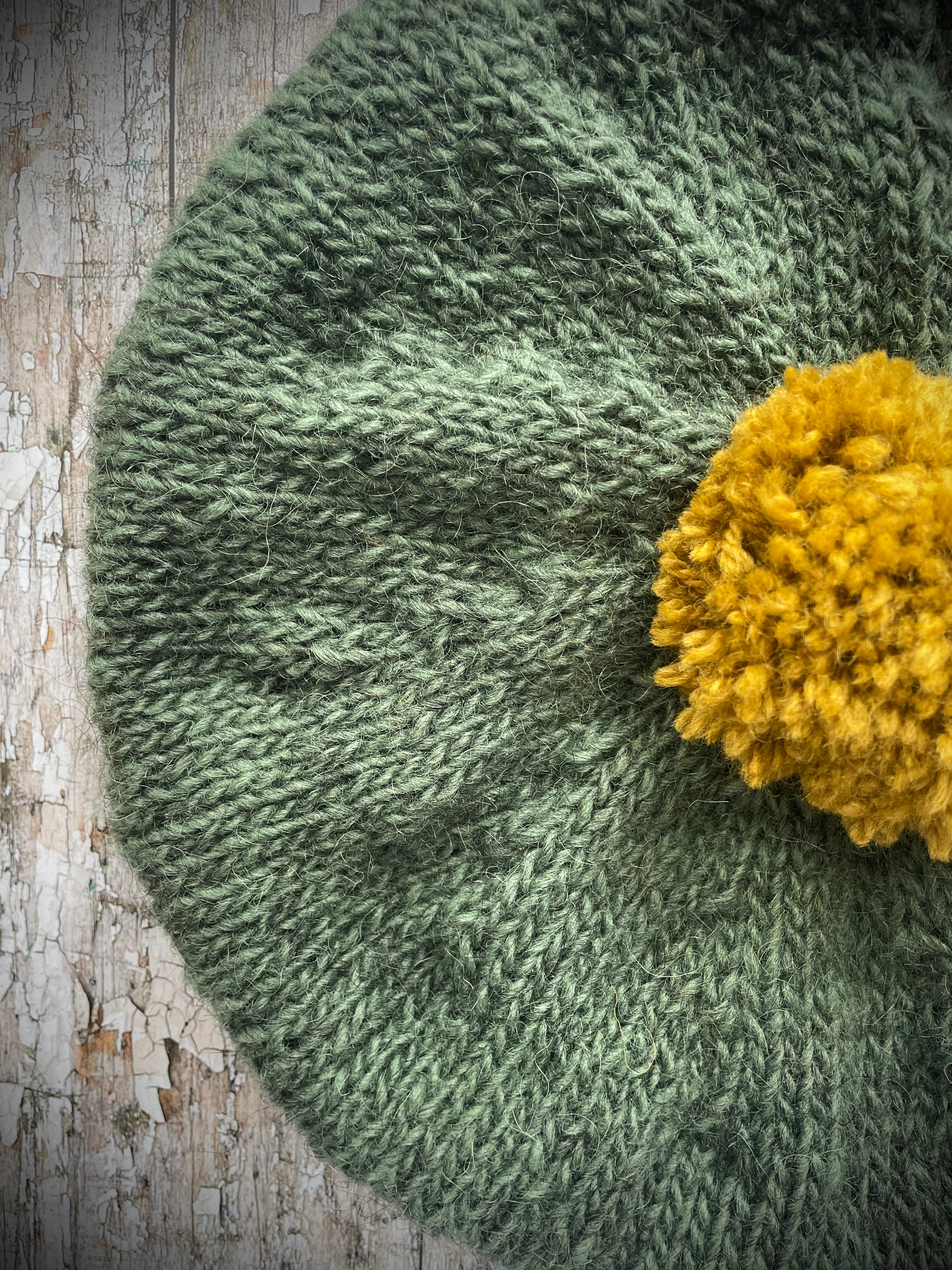 Beautifully hand knitted beret in sage green heather Icelandic wool and a rich yellow BFL wool, perfect for keeping your head warm on cold days, with a ribbed band of sage green that gives the hat a snug fit.

SIZE: Adult.

CARE: hand wash or machine wash on wool cycle at 30 degrees, dry flat, do not tumble dry.