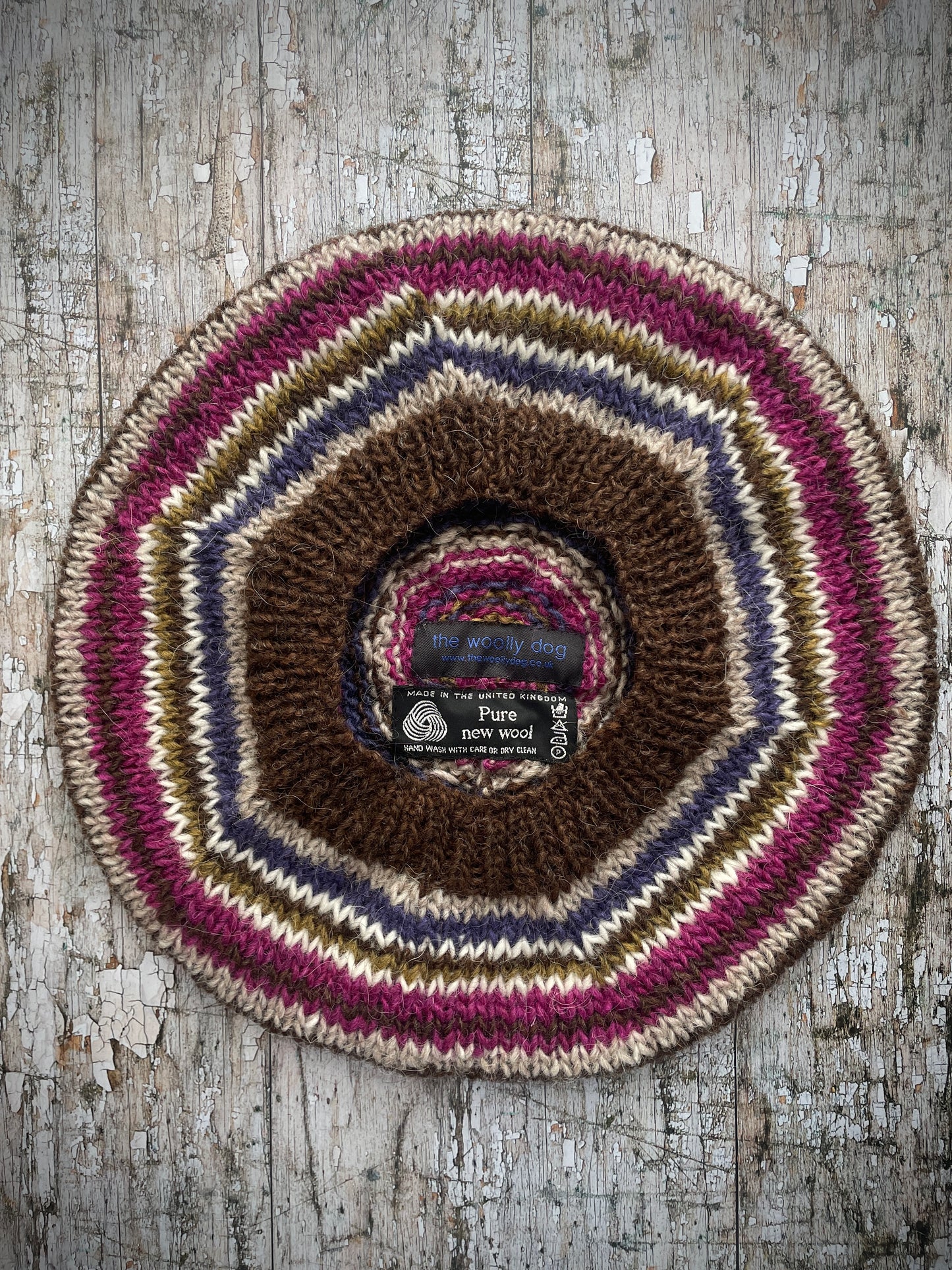 Classic 40's Style Beret no.10
Beautifully hand knitted beret in Icelandic pure wool, perfect for keeping your head warm on cold days and adding a touch of 40's style to any outfit. Knitted in dark chocolate brown, oat, lavender, white, kelp and fuchsia stripes, with a dark chocolate brown ribbed band that gives the hat a snug fit.

ONE SIZE: adult.
CARE: hand wash or machine wash on wool cycle at 30 degrees, dry flat, do not tumble dry.