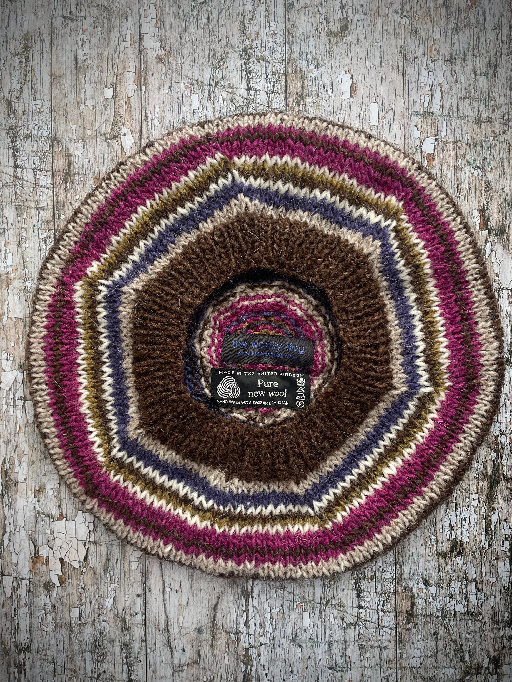 Classic 40's Style Beret no.10
Beautifully hand knitted beret in Icelandic pure wool, perfect for keeping your head warm on cold days and adding a touch of 40's style to any outfit. Knitted in dark chocolate brown, oat, lavender, white, kelp and fuchsia stripes, with a dark chocolate brown ribbed band that gives the hat a snug fit.

ONE SIZE: adult.
CARE: hand wash or machine wash on wool cycle at 30 degrees, dry flat, do not tumble dry.