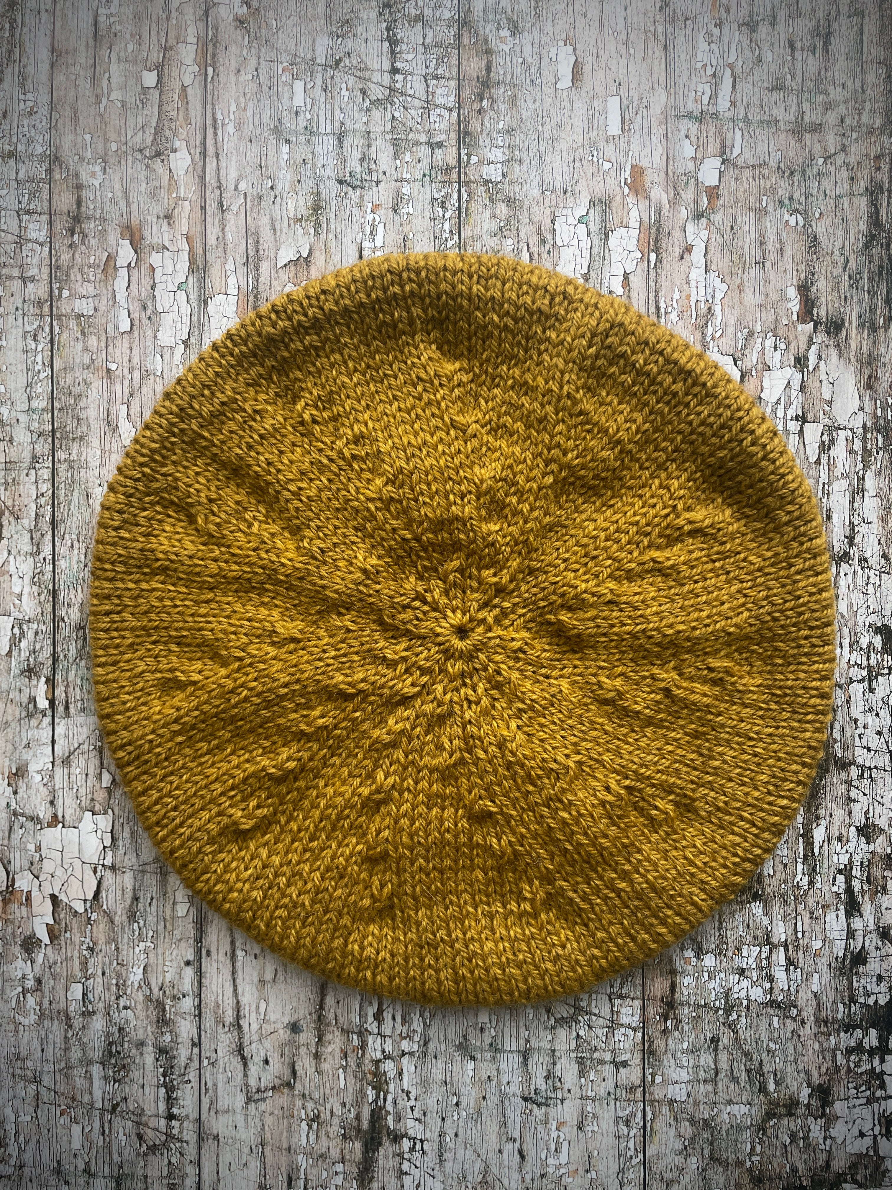 Beautifully hand knitted beret in a rich yellow BFL wool, perfect for keeping your head warm on cold days, with a ribbed band of sage green heather Icelandic wool that gives the hat a snug fit.

SIZE: small.

CARE: hand wash or machine wash on wool cycle at 30 degrees, dry flat, do not tumble dry.
