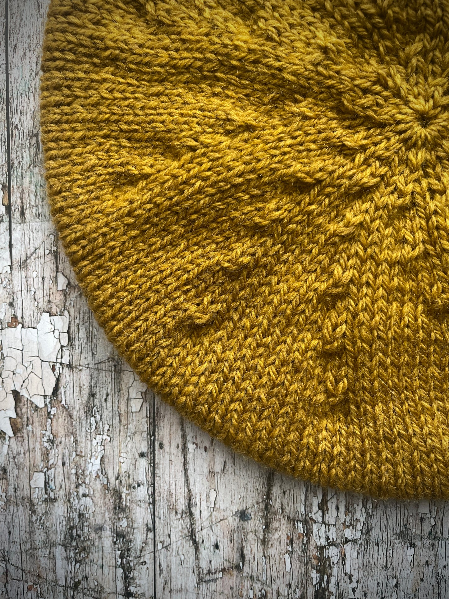 Beautifully hand knitted beret in a rich yellow BFL wool, perfect for keeping your head warm on cold days, with a ribbed band of sage green heather Icelandic wool that gives the hat a snug fit.

SIZE: small.

CARE: hand wash or machine wash on wool cycle at 30 degrees, dry flat, do not tumble dry.