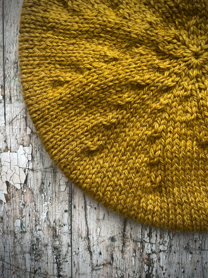 Beautifully hand knitted beret in a rich yellow BFL wool, perfect for keeping your head warm on cold days, with a ribbed band of sage green heather Icelandic wool that gives the hat a snug fit.

SIZE: small.

CARE: hand wash or machine wash on wool cycle at 30 degrees, dry flat, do not tumble dry.