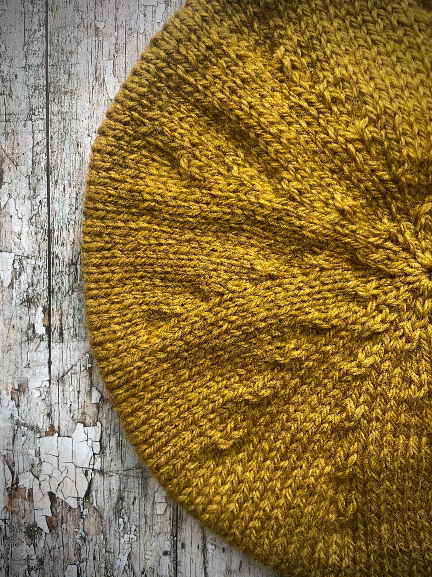 Beautifully hand knitted beret in a rich yellow BFL wool, perfect for keeping your head warm on cold days, with a ribbed band of sage green heather Icelandic wool that gives the hat a snug fit.

SIZE: small.

CARE: hand wash or machine wash on wool cycle at 30 degrees, dry flat, do not tumble dry.
