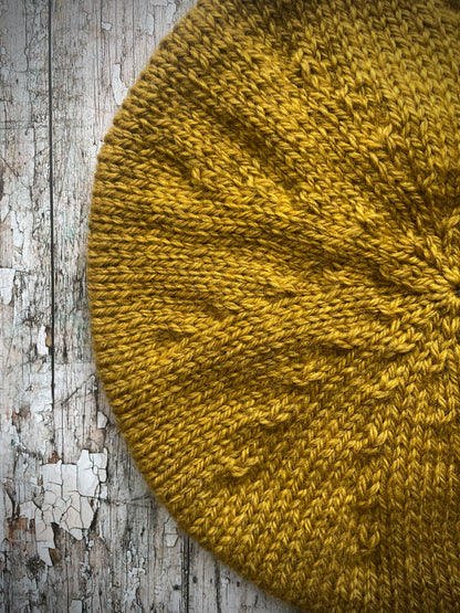 Beautifully hand knitted beret in a rich yellow BFL wool, perfect for keeping your head warm on cold days, with a ribbed band of sage green heather Icelandic wool that gives the hat a snug fit.

SIZE: small.

CARE: hand wash or machine wash on wool cycle at 30 degrees, dry flat, do not tumble dry.