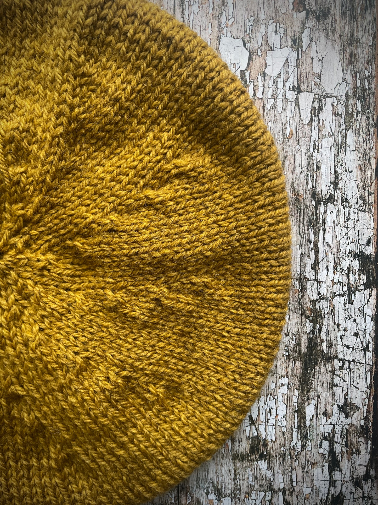 Beautifully hand knitted beret in a rich yellow BFL wool, perfect for keeping your head warm on cold days, with a ribbed band of sage green heather Icelandic wool that gives the hat a snug fit.

SIZE: small.

CARE: hand wash or machine wash on wool cycle at 30 degrees, dry flat, do not tumble dry.