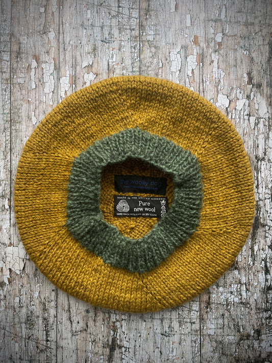 Beautifully hand knitted beret in a rich yellow BFL wool, perfect for keeping your head warm on cold days, with a ribbed band of sage green heather Icelandic wool that gives the hat a snug fit.

SIZE: small.

CARE: hand wash or machine wash on wool cycle at 30 degrees, dry flat, do not tumble dry.