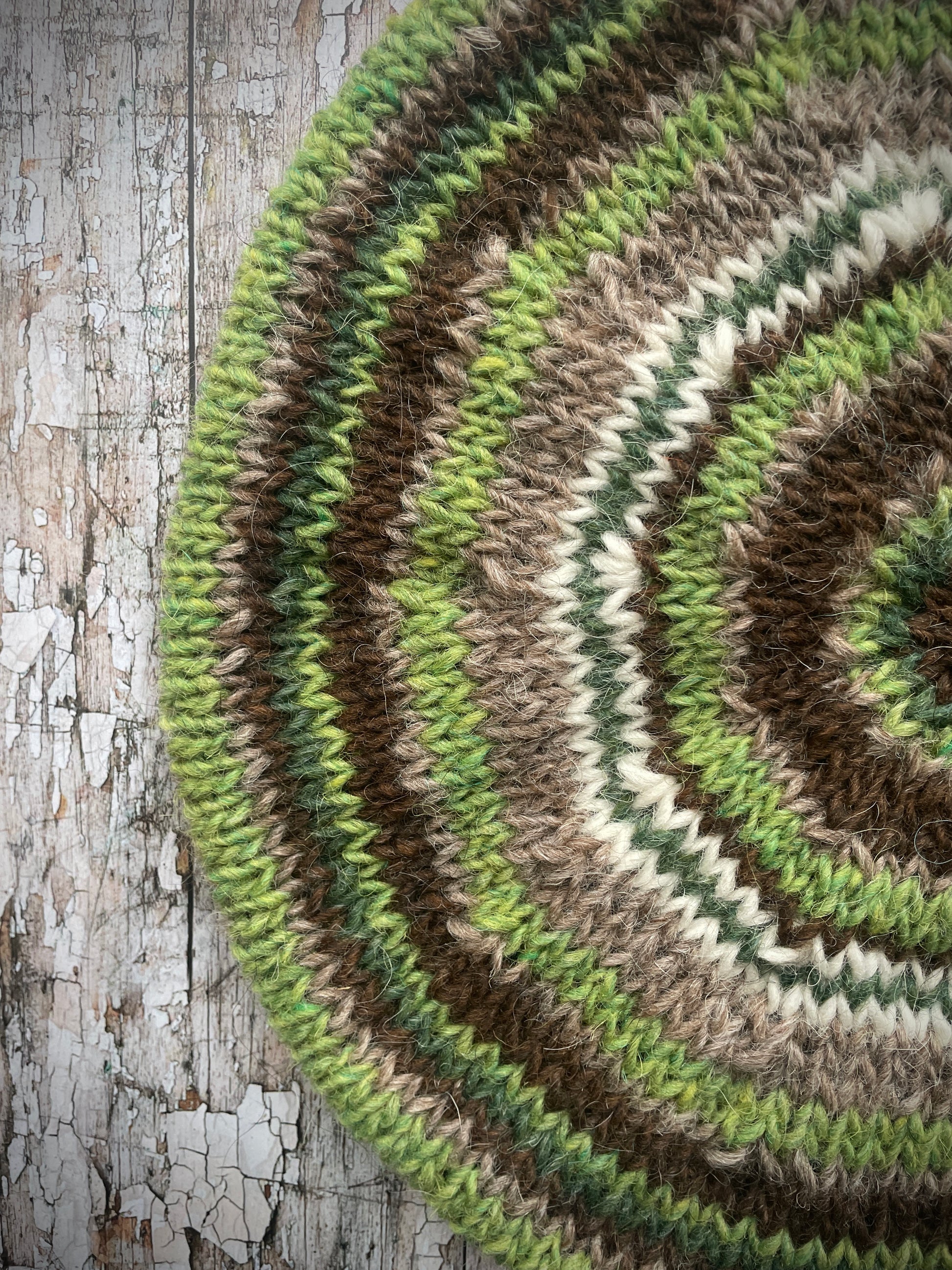 Classic 40's Style Beret no.42

Beautifully hand knitted beret in Icelandic Lettlopi wool, perfect for keeping your head warm on cold days and adding a touch of 40's style to any outfit. Knitted in oat heather, dark chocolate brown, bright green, white and pine stripes, with an oat heather ribbed band that gives the hat a snug fit.

SIZE: adult.

CARE: hand wash or machine wash on wool cycle at 30 degrees, dry flat, do not tumble dry.