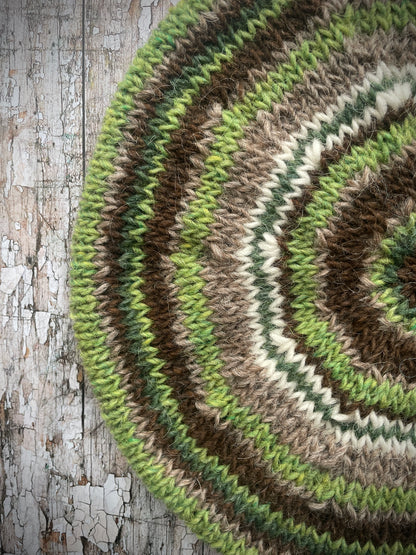 Classic 40's Style Beret no.42

Beautifully hand knitted beret in Icelandic Lettlopi wool, perfect for keeping your head warm on cold days and adding a touch of 40's style to any outfit. Knitted in oat heather, dark chocolate brown, bright green, white and pine stripes, with an oat heather ribbed band that gives the hat a snug fit.

SIZE: adult.

CARE: hand wash or machine wash on wool cycle at 30 degrees, dry flat, do not tumble dry.