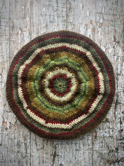 CLASSIC 40's STYLE ADULT'S BERET style 21

Beautifully hand knitted beret in Icelandic pure wool, perfect for keeping your head warm on cold days and adding a touch of 40's style to any outfit. Knitted in dark kelp, pebble, dark chocolate, green, sage green heather, garnet and frostbite stripes, with a dark kelp ribbed band that gives the hat a snug fit.

ONE SIZE: adult.
CARE: hand wash or machine wash on wool cycle at 30 degrees, dry flat, do not tumble dry.