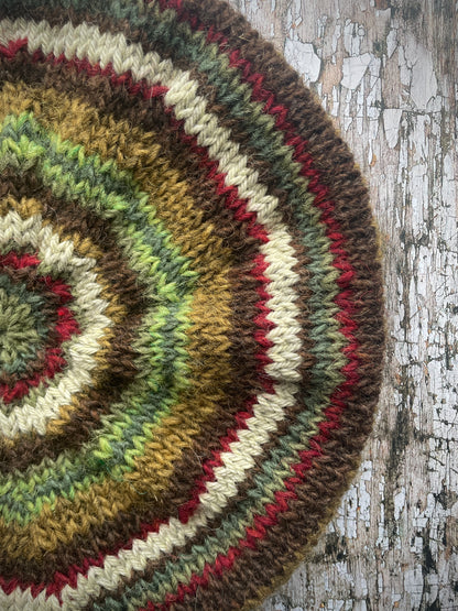 CLASSIC 40's STYLE ADULT'S BERET style 21

Beautifully hand knitted beret in Icelandic pure wool, perfect for keeping your head warm on cold days and adding a touch of 40's style to any outfit. Knitted in dark kelp, pebble, dark chocolate, green, sage green heather, garnet and frostbite stripes, with a dark kelp ribbed band that gives the hat a snug fit.

ONE SIZE: adult.
CARE: hand wash or machine wash on wool cycle at 30 degrees, dry flat, do not tumble dry.