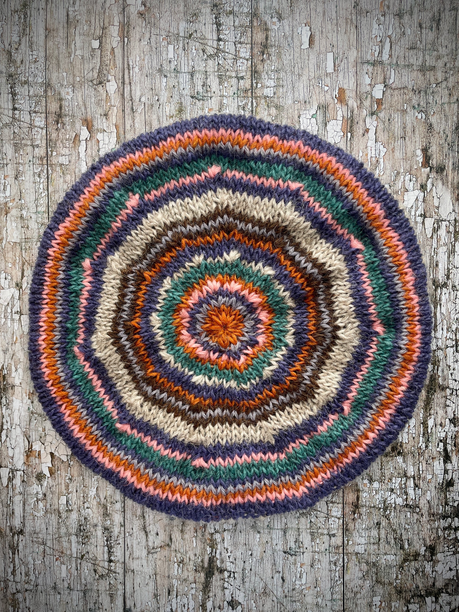 Beautifully hand knitted beret in Icelandic wool, perfect for keeping your head warm on cold days and adding a touch of 40's style to any outfit. Knitted in oat, viridian, violet, dark chocolate, mauve, pink and orange stripes, with an oat ribbed band that gives the hat a snug fit.

SIZE: adult.

CARE: hand wash or machine wash on wool cycle at 30 degrees, dry flat, do not tumble dry.