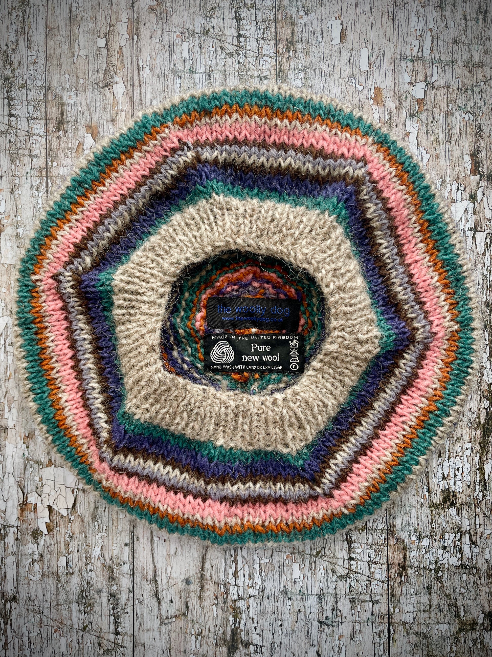 Beautifully hand knitted beret in Icelandic wool, perfect for keeping your head warm on cold days and adding a touch of 40's style to any outfit. Knitted in oat, viridian, violet, dark chocolate, mauve, pink and orange stripes, with an oat ribbed band that gives the hat a snug fit.

SIZE: adult.

CARE: hand wash or machine wash on wool cycle at 30 degrees, dry flat, do not tumble dry.