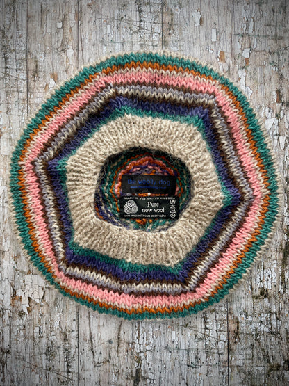 Beautifully hand knitted beret in Icelandic wool, perfect for keeping your head warm on cold days and adding a touch of 40's style to any outfit. Knitted in oat, viridian, violet, dark chocolate, mauve, pink and orange stripes, with an oat ribbed band that gives the hat a snug fit.

SIZE: adult.

CARE: hand wash or machine wash on wool cycle at 30 degrees, dry flat, do not tumble dry.