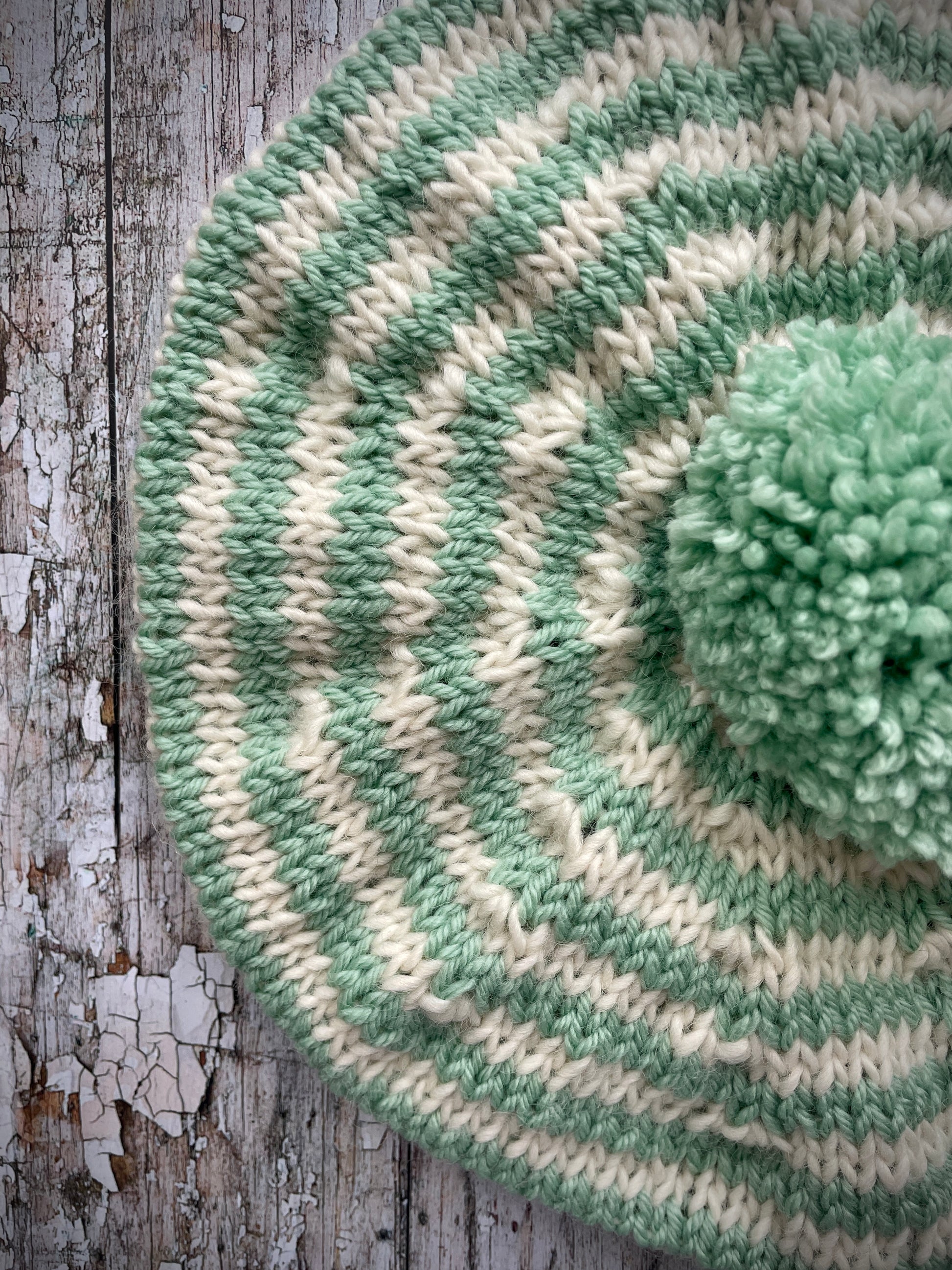 CHILDREN'S PISTACHIO + CREAM STRIPED WOOL BERET
Beautifully hand knitted beret in soft pure wool and merino wool, perfect for keeping little heads warm on cold days. Knitted in nautical Breton stripes of pistachio green and cream, with a big green pom and green ribbed band that gives the hat a snug fit. It would look lovely on boys or girls.

SIZE: child 6 - 24 mths.
Diameter approximately: 26cm / 10+1/4".
CARE: hand wash or machine wash on wool cycle at 30 degrees, dry flat, do not tumble dry.