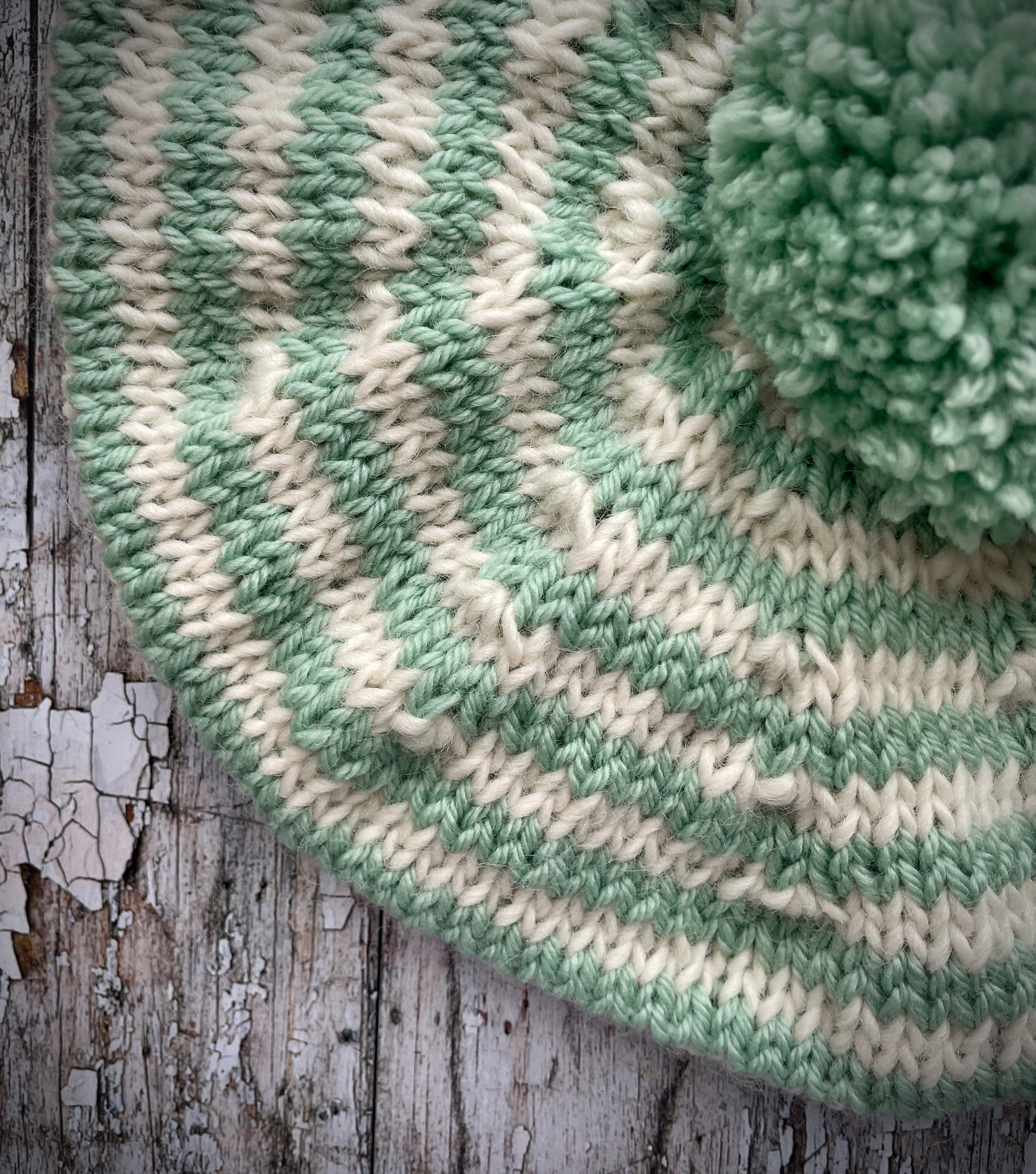 CHILDREN'S PISTACHIO + CREAM STRIPED WOOL BERET
Beautifully hand knitted beret in soft pure wool and merino wool, perfect for keeping little heads warm on cold days. Knitted in nautical Breton stripes of pistachio green and cream, with a big green pom and green ribbed band that gives the hat a snug fit. It would look lovely on boys or girls.

SIZE: child 6 - 24 mths.
Diameter approximately: 26cm / 10+1/4".
CARE: hand wash or machine wash on wool cycle at 30 degrees, dry flat, do not tumble dry.