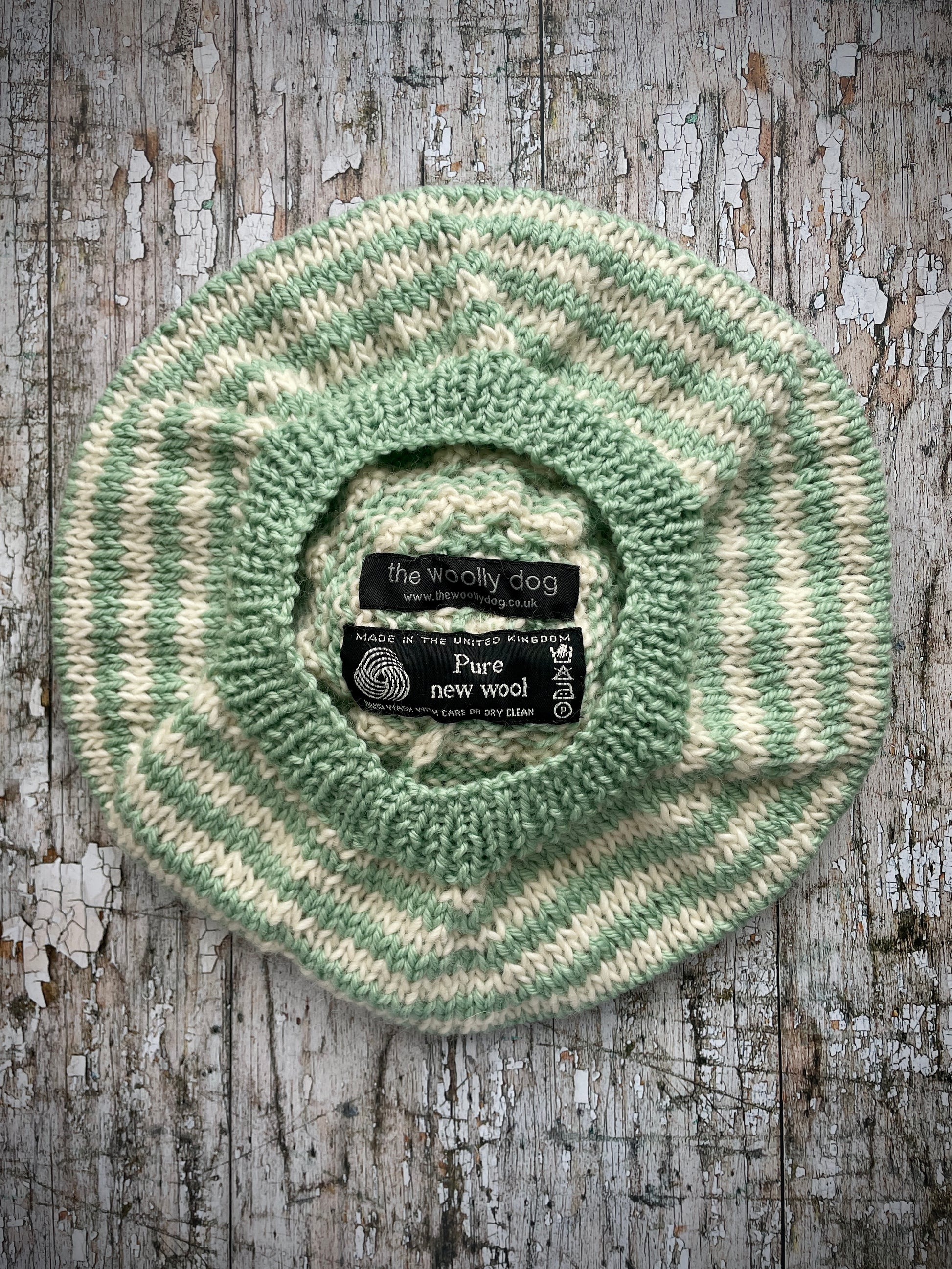 CHILDREN'S PISTACHIO + CREAM STRIPED WOOL BERET
Beautifully hand knitted beret in soft pure wool and merino wool, perfect for keeping little heads warm on cold days. Knitted in nautical Breton stripes of pistachio green and cream, with a big green pom and green ribbed band that gives the hat a snug fit. It would look lovely on boys or girls.

SIZE: child 6 - 24 mths.
Diameter approximately: 26cm / 10+1/4".
CARE: hand wash or machine wash on wool cycle at 30 degrees, dry flat, do not tumble dry.