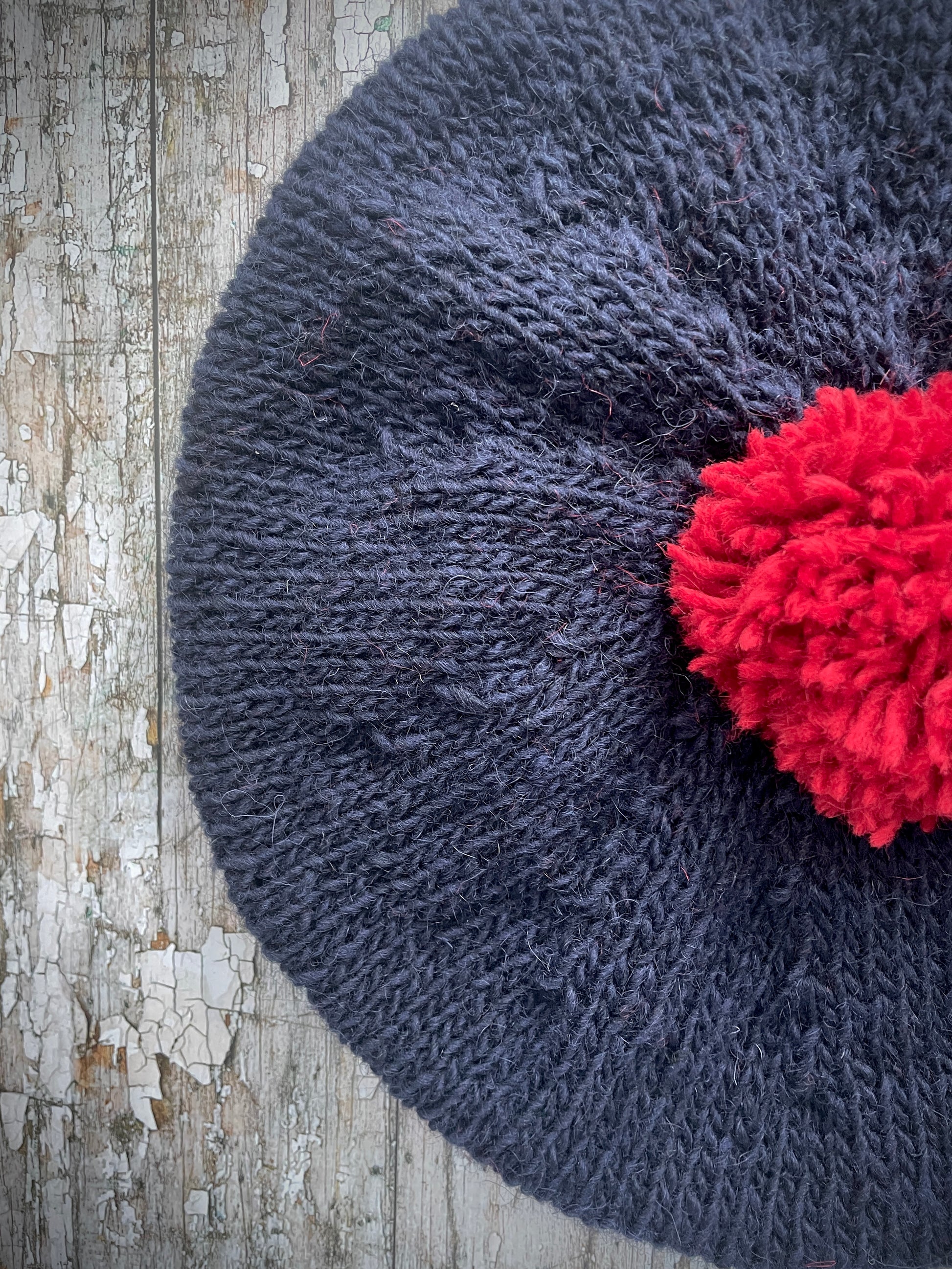 Hand Knitted Wool Beret Navy Blue + Red

Beautifully hand knitted beret in Icelandic pure wool, perfect for keeping your head warm on cold days. Knitted in a dark navy blue colour with a bright red pom and navy blue ribbed band that gives the hat a snug fit.

SIZE: adult.

CARE: hand wash or machine wash on wool cycle at 30 degrees, dry flat, do not tumble dry.