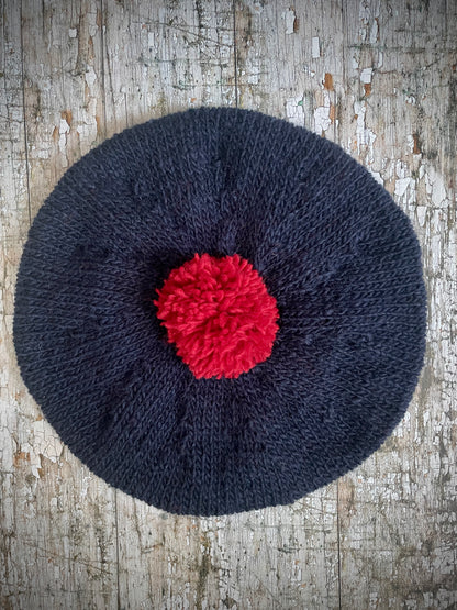 Hand Knitted Wool Beret Navy Blue + Red

Beautifully hand knitted beret in Icelandic pure wool, perfect for keeping your head warm on cold days. Knitted in a dark navy blue colour with a bright red pom and navy blue ribbed band that gives the hat a snug fit.

SIZE: adult.

CARE: hand wash or machine wash on wool cycle at 30 degrees, dry flat, do not tumble dry.
