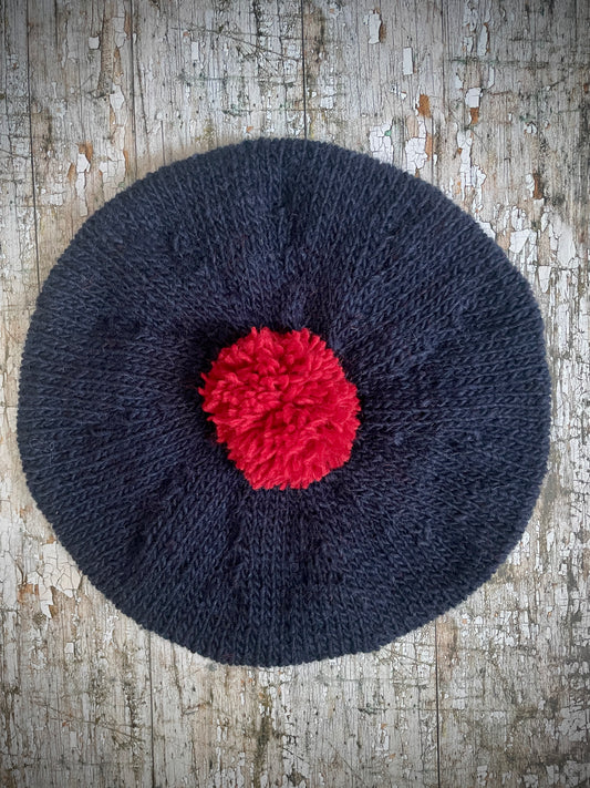 Hand Knitted Wool Beret Navy Blue + Red

Beautifully hand knitted beret in Icelandic pure wool, perfect for keeping your head warm on cold days. Knitted in a dark navy blue colour with a bright red pom and navy blue ribbed band that gives the hat a snug fit.

SIZE: adult.

CARE: hand wash or machine wash on wool cycle at 30 degrees, dry flat, do not tumble dry.