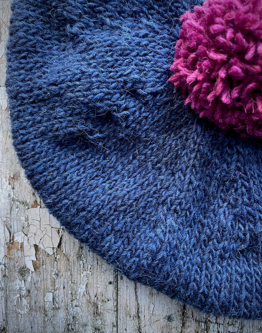 Hand Knitted Wool Indigo + Fuchsia Beret

Beautifully hand knitted beret in Icelandic pure wool, perfect for keeping your head warm on cold days. Knitted in a beautiful indigo blue, with a big fuchsia pom and indigo ribbed band that gives the hat a snug fit.

SIZE: adult.

CARE: hand wash or machine wash on wool cycle at 30 degrees, dry flat, do not tumble dry.
